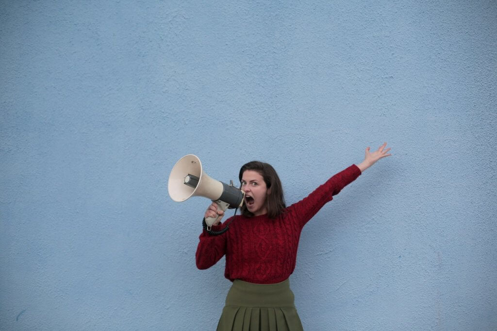 Woman using megaphone-to-shout about brand advocacy • Kevin Harrington Woman using megaphone-to-shout about brand advocacy