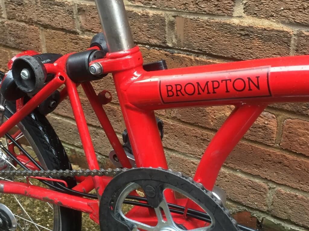 red Brompton bike • Kevin Harrington red Brompton bike