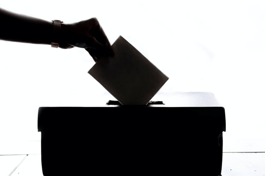 vote paper being dropped into ballot box • Kevin Harrington vote paper being dropped into ballot box